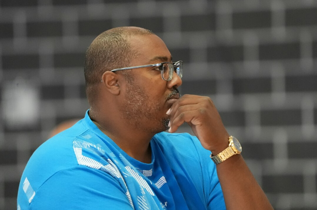 Portrait of a man wearing glasses and a blue shirt